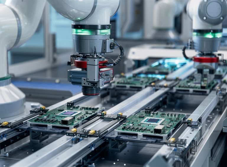 Component Installation and Quality Control of Circuit Board. Fully Automated PCB Assembly Line Equipped with High Precision Robot Arms at Electronics Factory. Electronic Devices Manufacturing